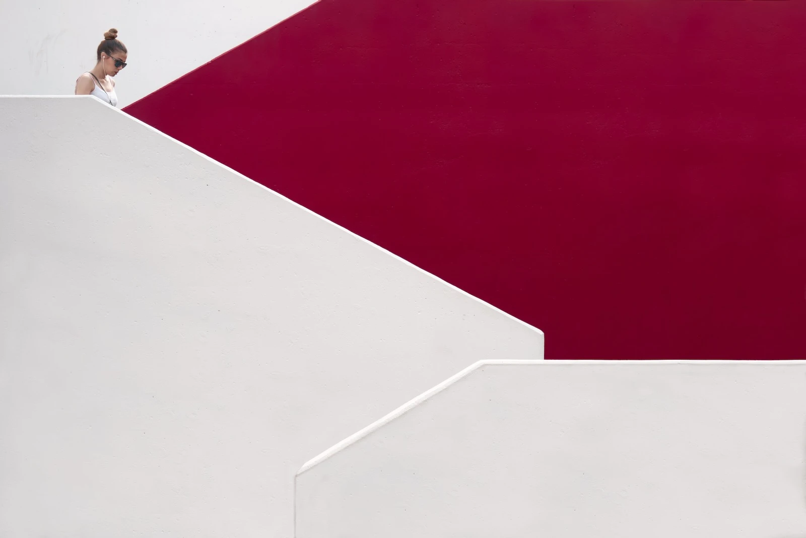 woman walking down a red staircase.