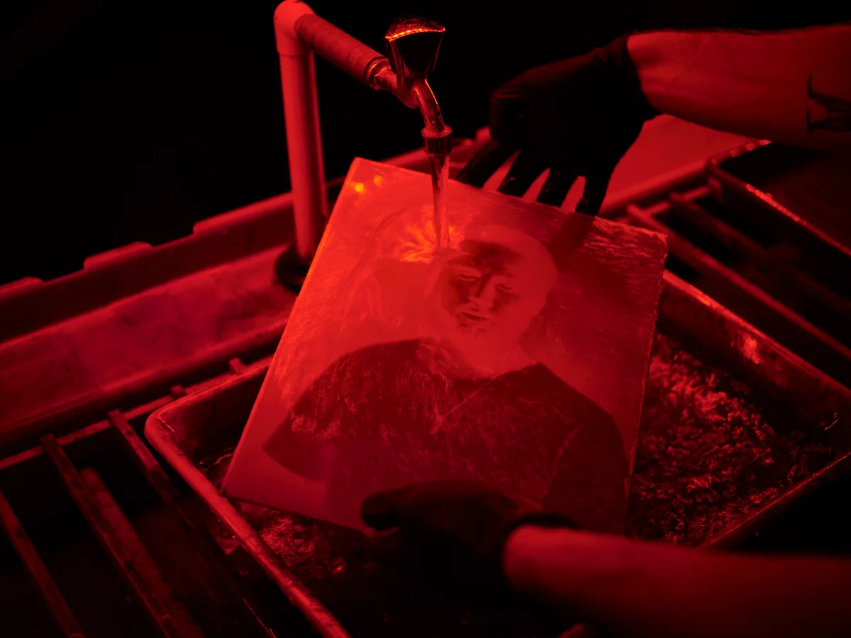 Image being washed in a red light room.