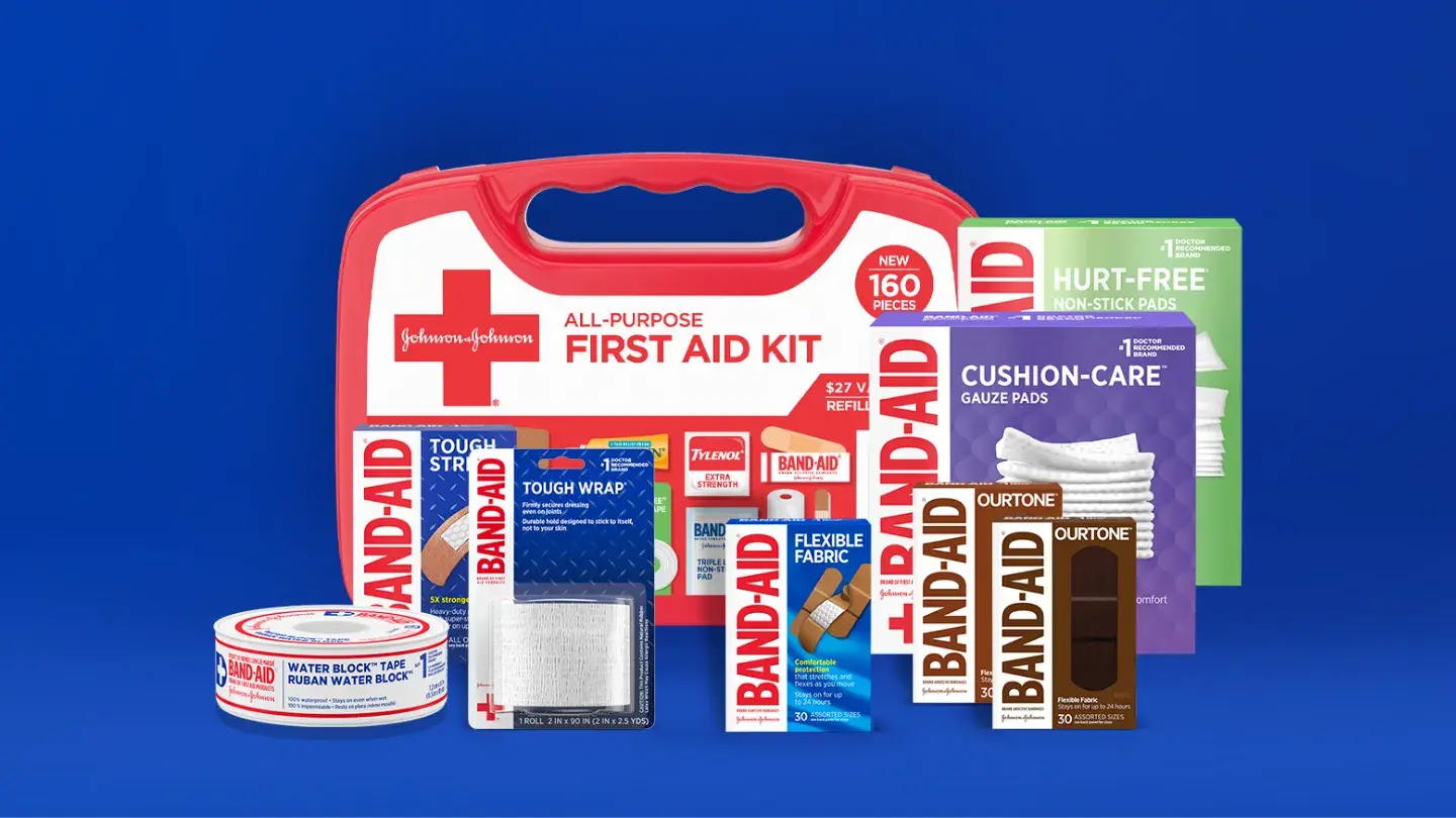 All-purpose first aid kit by Band-Aid Brand, featuring various Band-Aid products, gauze pads, non-stick pads, and a roll of water block tape against a blue background.