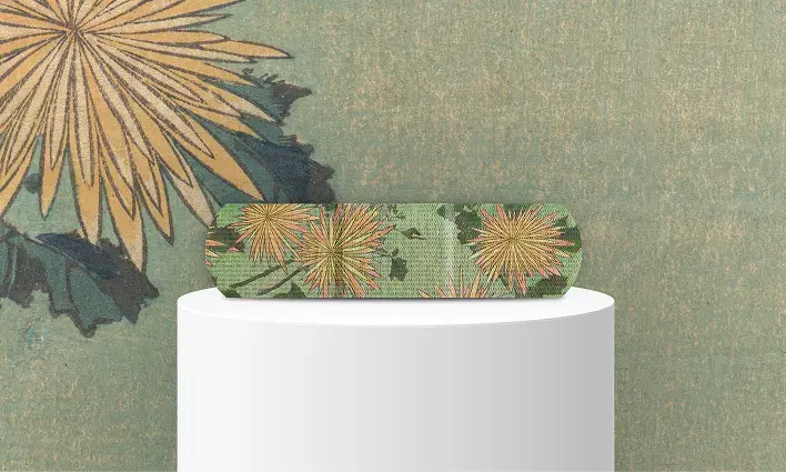 BAND-AID®️ Brand featuring a vibrant floral design with yellow chrysanthemums on a green background, inspired by Japanese art, part of THE MET collaboration.