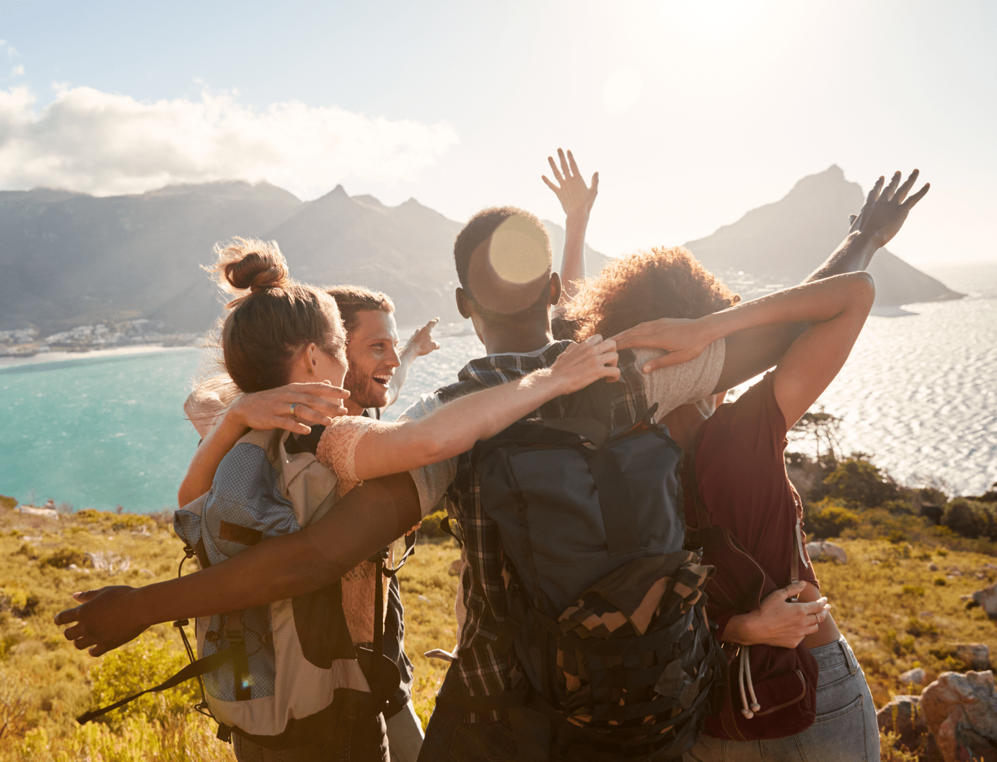 Friends hugging in front of a lake