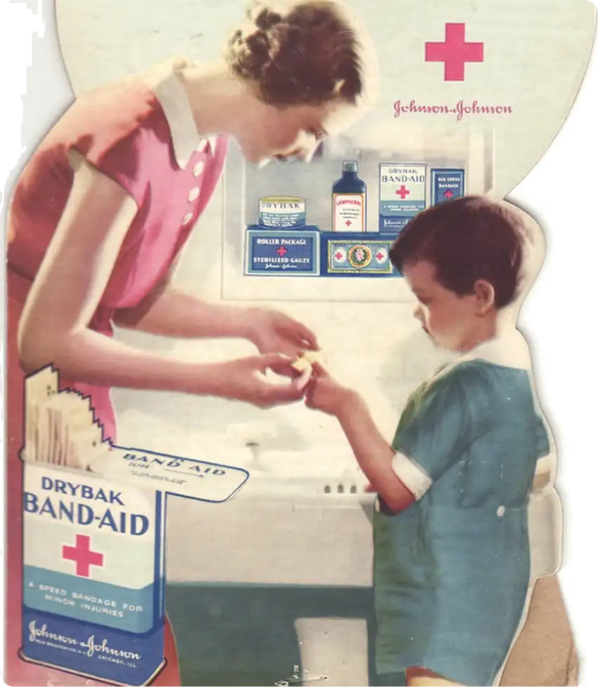 Woman putting a waterproof BAND-AID® Brand DryBak on boy