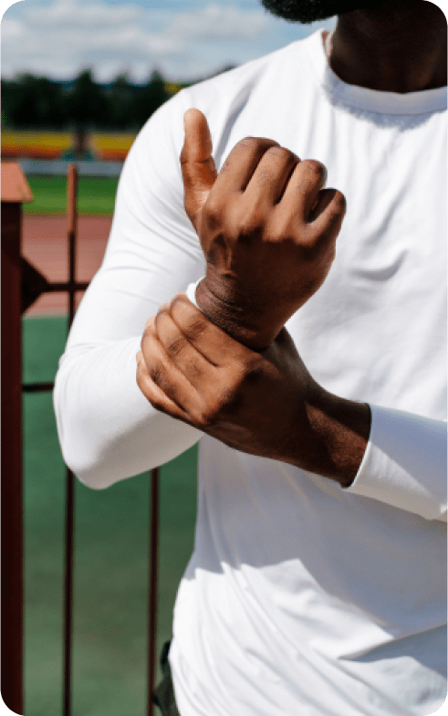 Man grasping his sprained wrist.