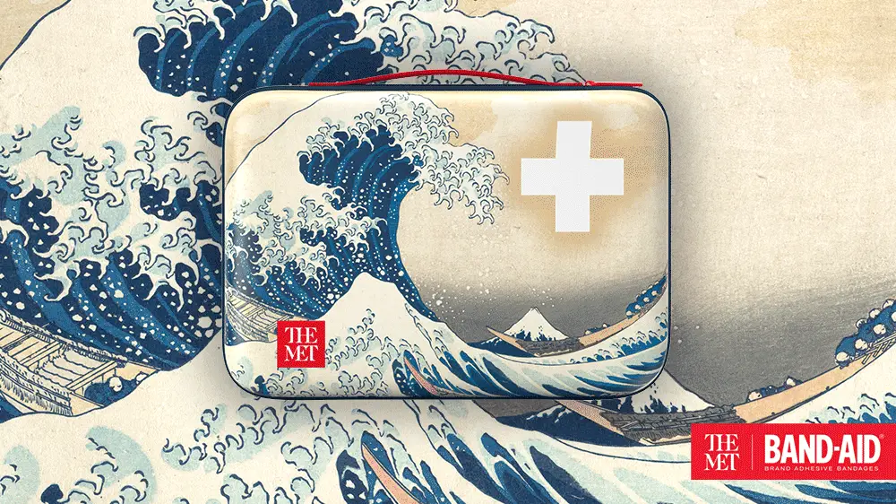 BAND-AID® Brand case featuring The Great Wave off Kanagawa design, part of THE MET collaboration, with a prominent white cross symbol and the The Met logo.