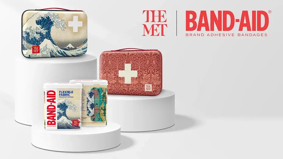 A promotional image showcasing BAND-AID brand bandages in collaboration with The Met, featuring a blue wave hard case, a red soft case with a white cross, and two containers of bandages. The Met and BAND-AID logos are displayed in the top right corner. 