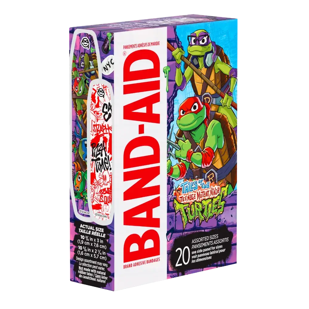 Behold, a box of Band-Aid brand adhesive bandages with the coolest Teenage Mutant Ninja Turtles graphics, showing you the actual size of the bandages. It's a mix of sizes, and the packaging is bursting with the vibrant artwork of Donatello and Raphael.