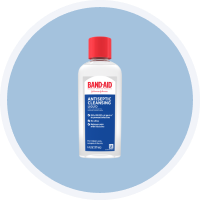 BAND-AID antiseptic cleansing liquid bottle with red cap, recommended for gently washing the area or applying an antiseptic wash to avoid bursting blisters.