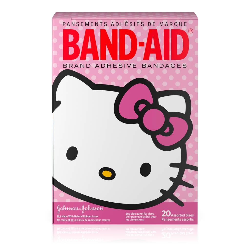 Band-Aid Brand Adhesive Bandages featuring Hello Kitty design, with 20 assorted sizes. Packaging shows a large Hello Kitty face with a pink bow on a pink polka dot background.