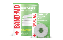 Band-Aid Hurt-Free Non-Stick Pads and Hurt-Free Wrap packaging, featuring green and white design with red Band-Aid logo and a cross symbol.