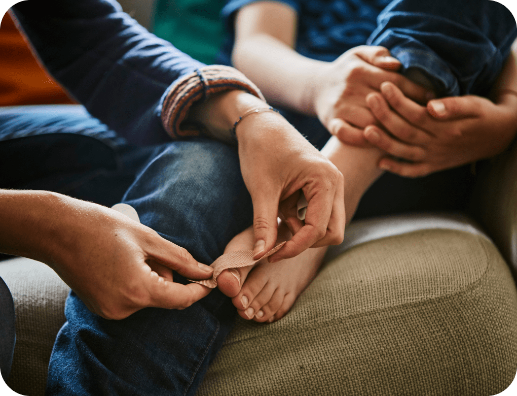 Person putting a bandage on a toe