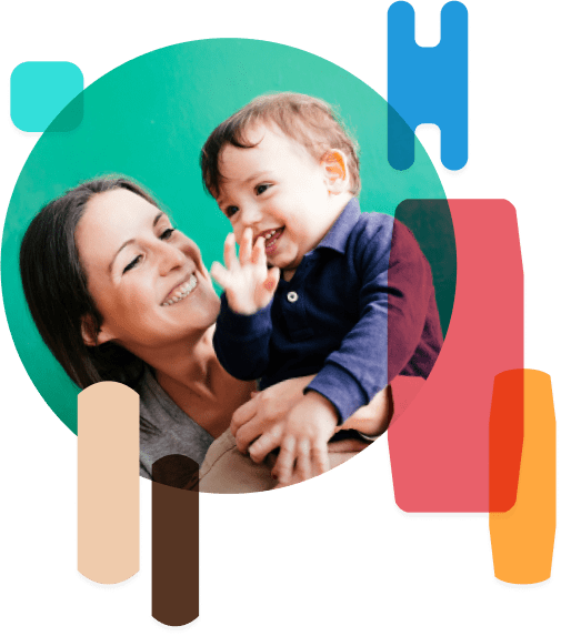 Woman smiling and holding up a small child.