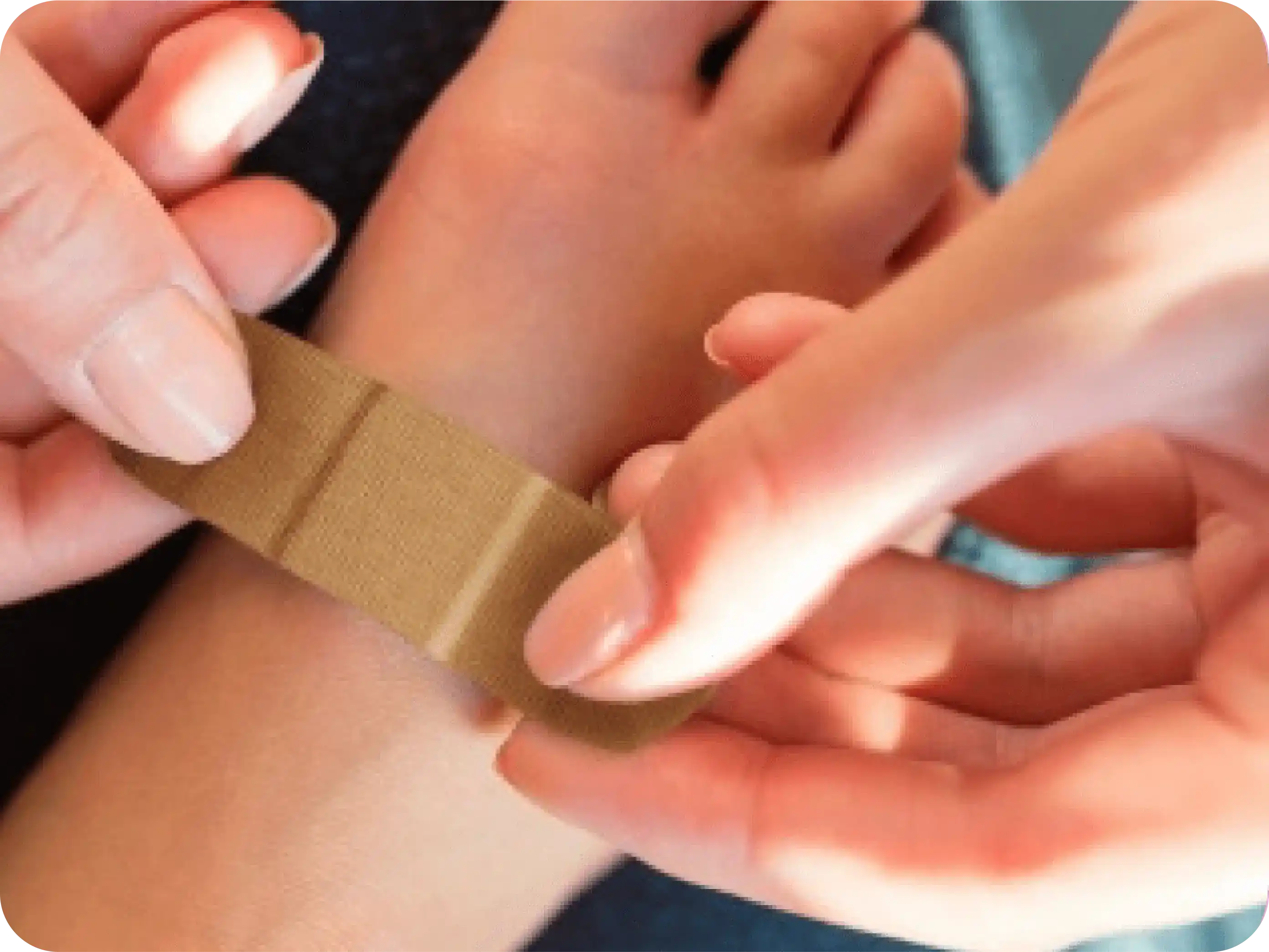 Adult placing a Band-Aid adhesive bandage on a child’s foot.