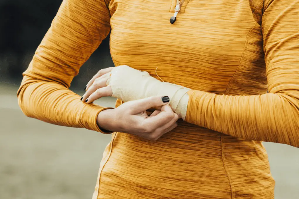 Woman wrapping her wrist.