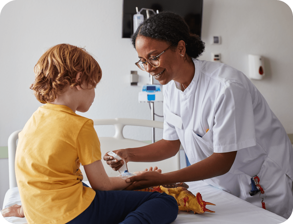 Doctor caring for a wound on a young child’s arm.