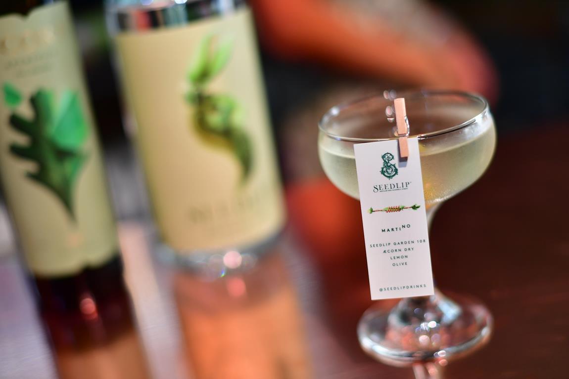 æcorn martino made in a designer glass with the recipe details pegged to the side of the glass