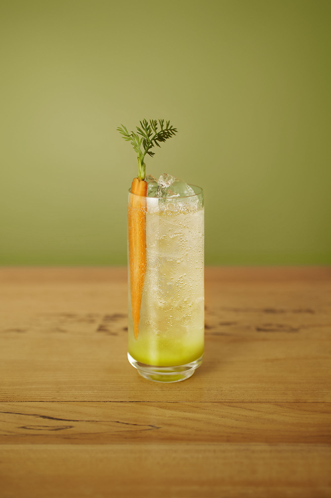 Mr McGregor cocktail in a tall glass garnished with a whole thin carrot