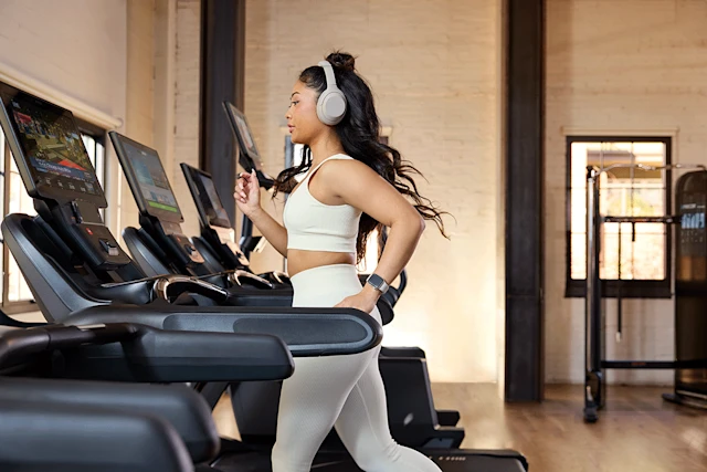 Exerciser using Precor strength equipment in a gym