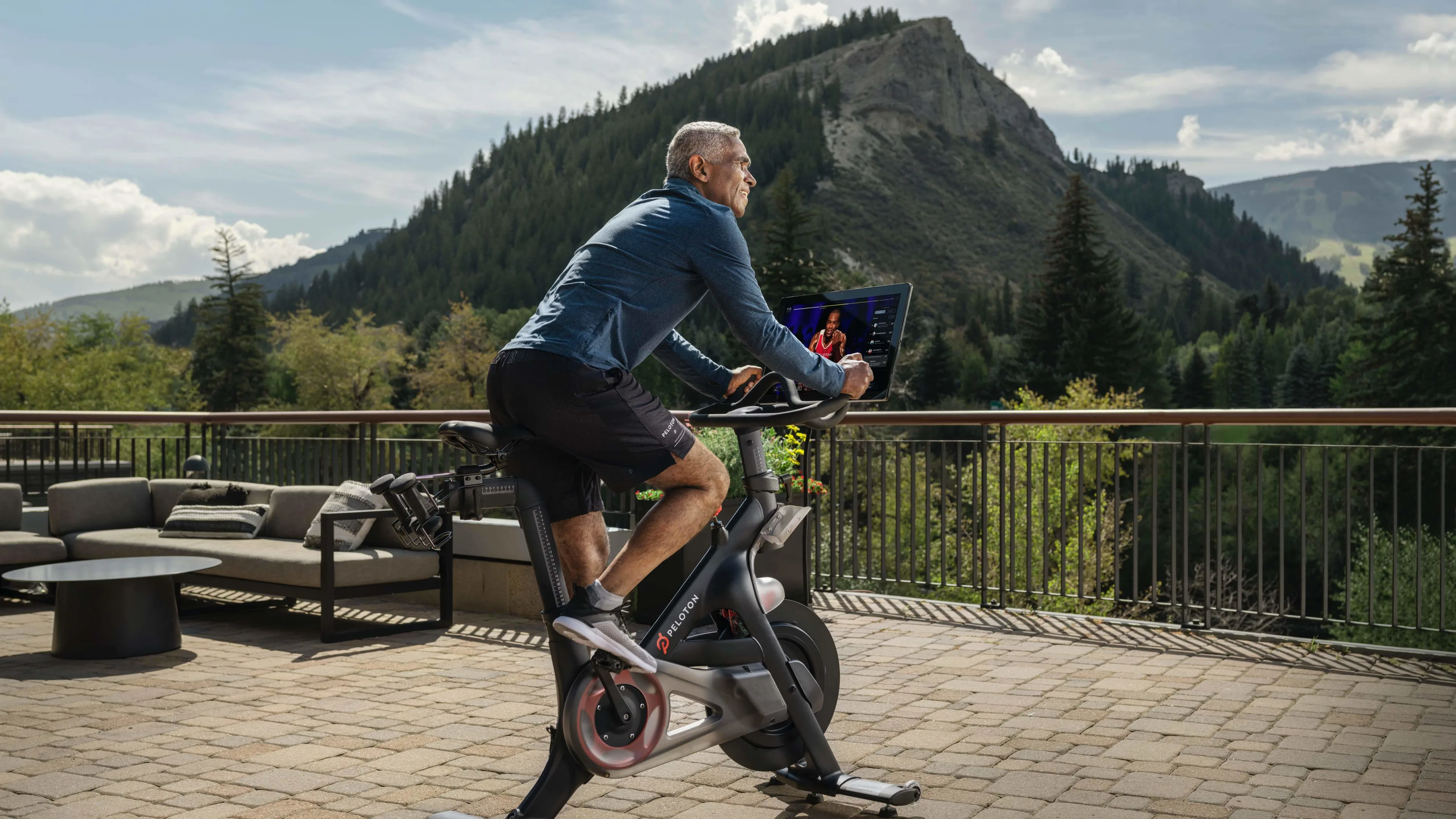 Exerciser using a Peloton stationary bike at a hotel