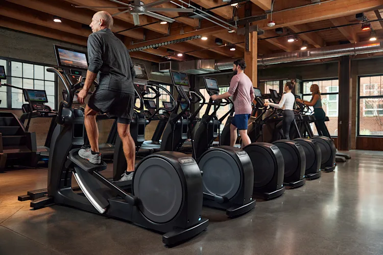 Precor Facility_Row of EFX with People plus other Precor Cardio with P94 P84 consoles.png