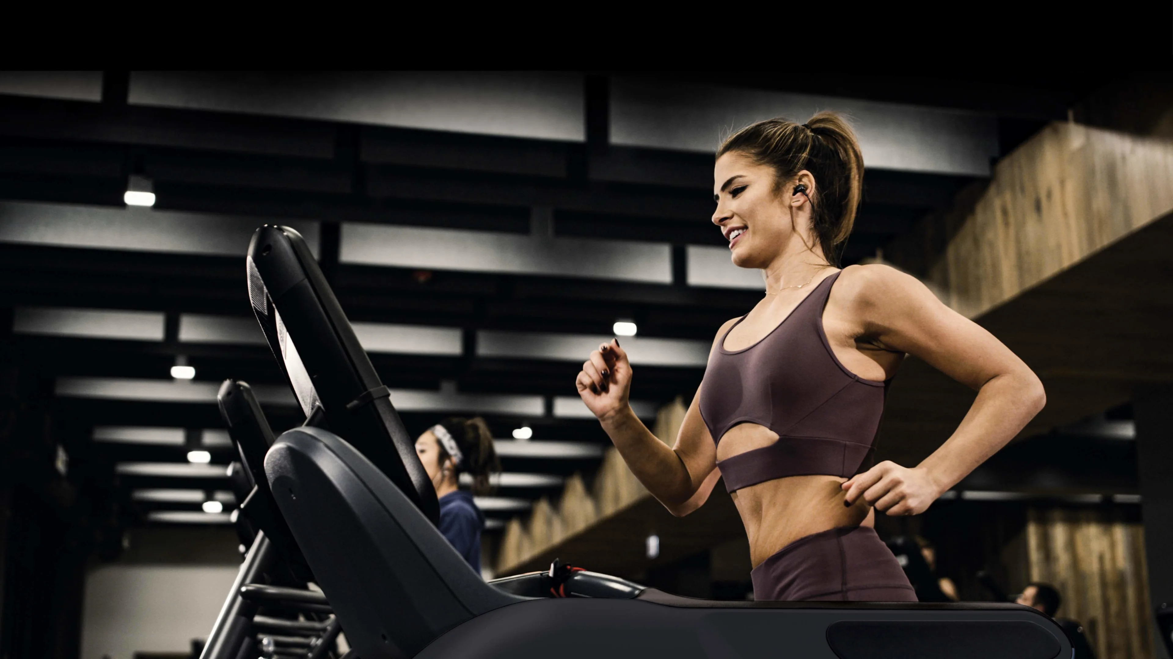 Gym member using a Precor treadmill