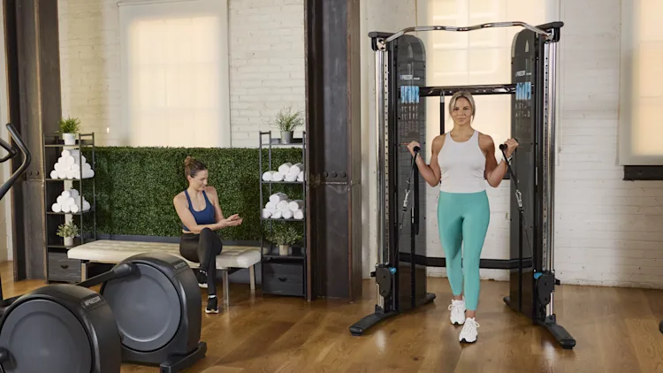 Precor Facility_People Working Out and on Phone_Cardio Row with FTS Glide and Free Weights Cropped.png