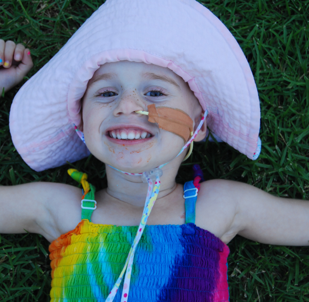 Addy smiling on grass
