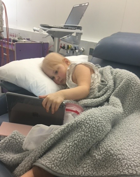 Amelia watching iPad in hospital