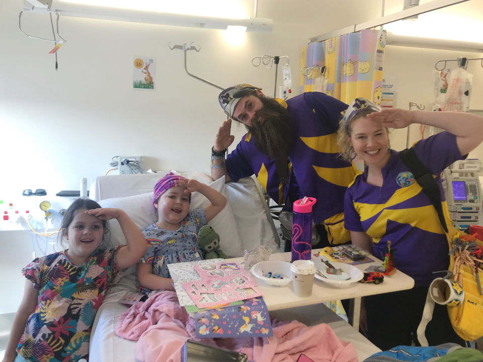 Paige in hospital with Captain Starlights and her sister