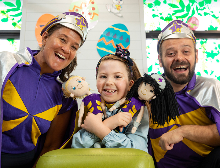 Anabela holding dolls with Captain Starlight - banner