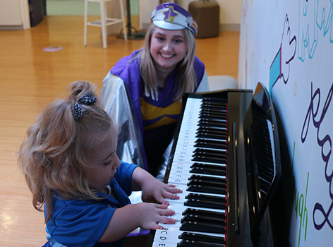 Helena playing the piano with Captain Starlight in the Starlight Express Room