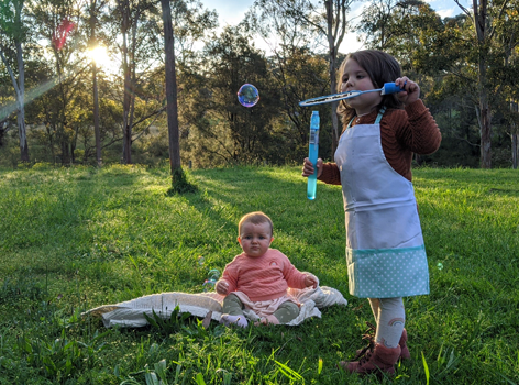 Harper and sister playing outdoors