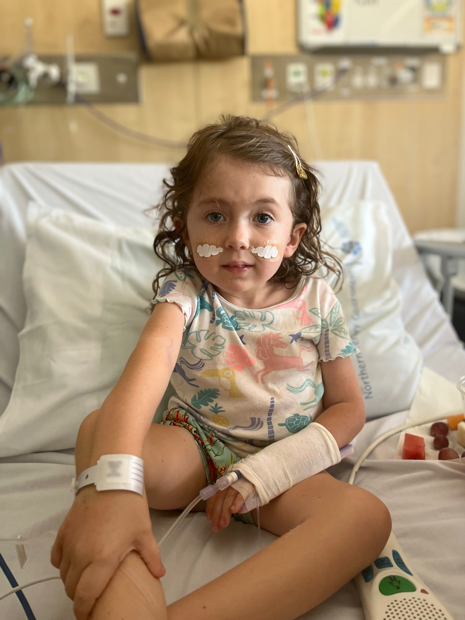 Avi sitting up in hospital bed