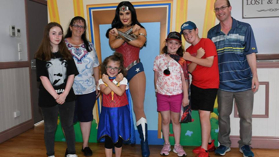 Madilyn and her family meeting Wonder Woman