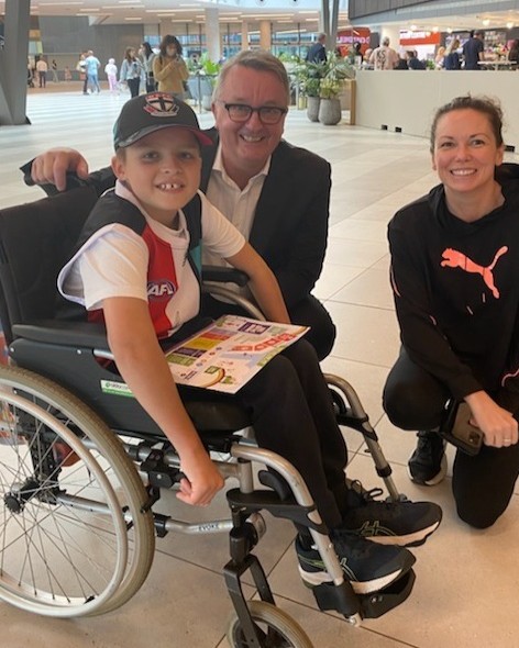 Tommy in wheelchair with parents