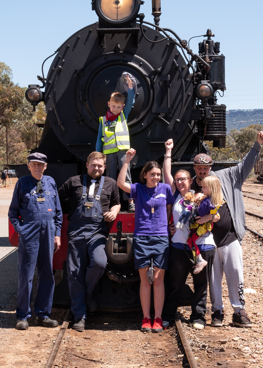 Broly with family and drivers at front of train