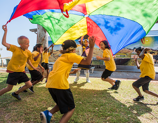 remote-community-kids-running-with-parachute