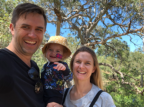 Ellie with her parents outdoors