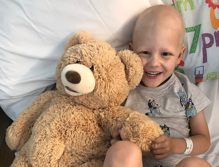 Henry holding teddy bear - banner