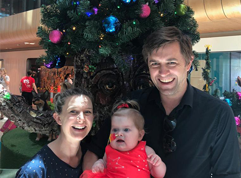 Ellie and her parents at Christmas