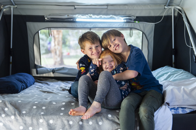 Nora and her brothers in her Starlight Wish camper trailer