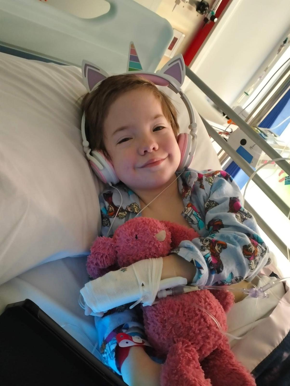 Amara with pink bunny in hospital