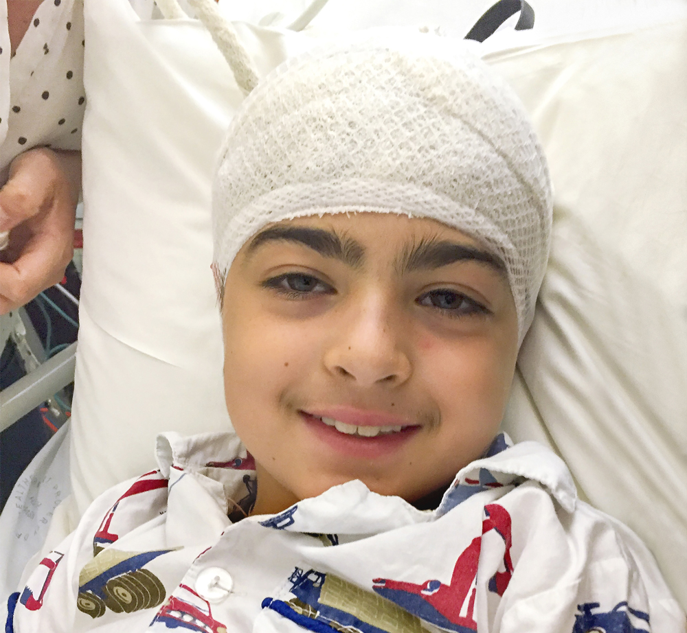 Syel in hospital bed with bandage