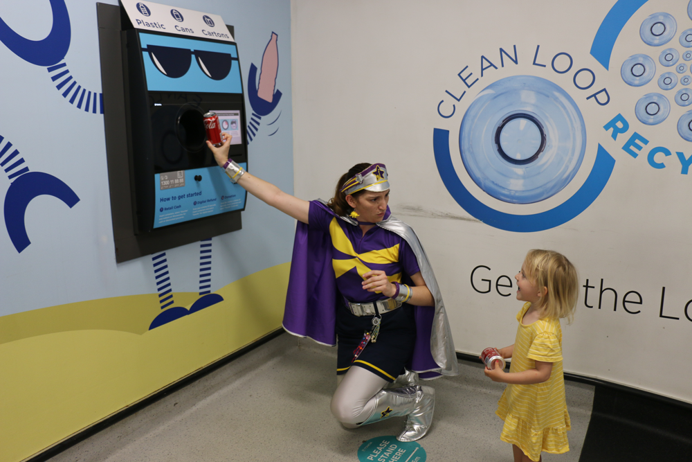 Captain Starlight and child recycling with TOMRA