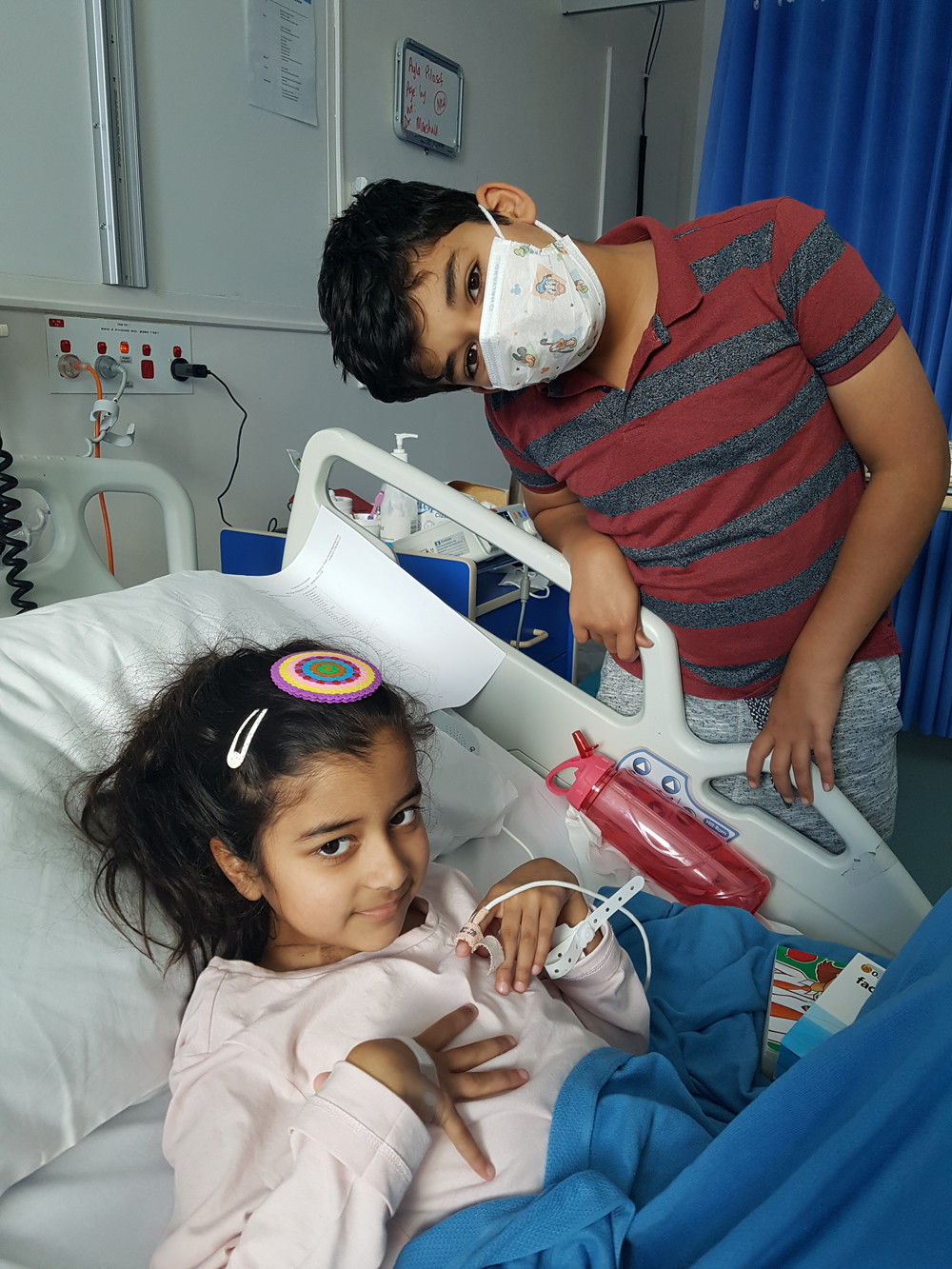 Ayla in hospital with brother visiting