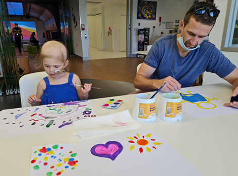 Chloe and dad doing craft in the Starlight Express Room