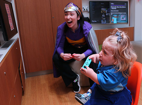Helena playing video games with Captain Starlight in the Starlight Express Room