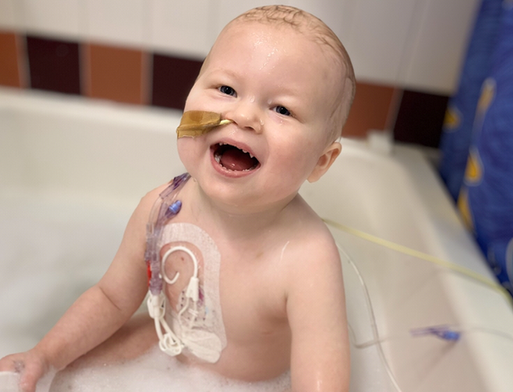 Eden smiling in bath - banner