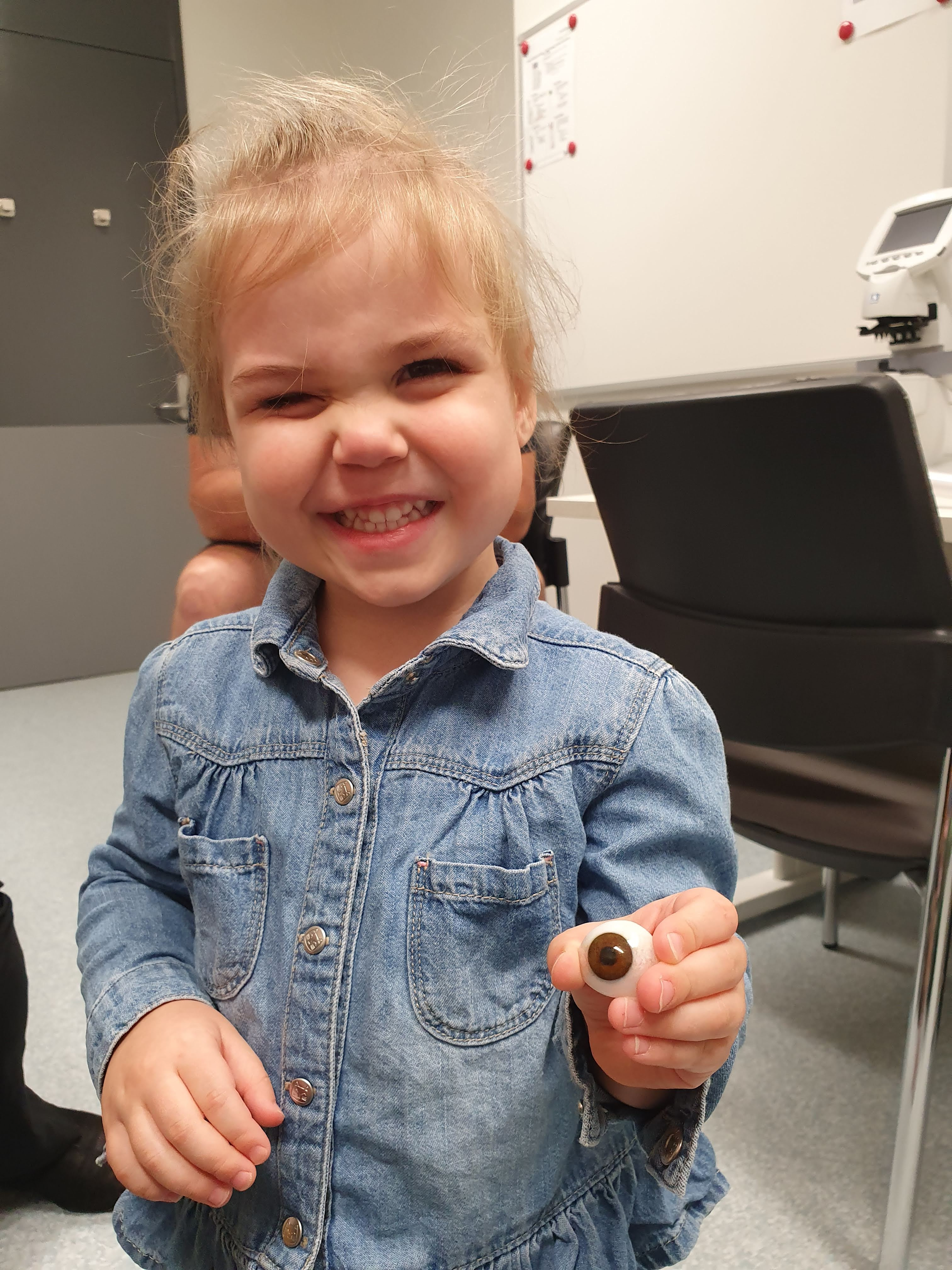 Thea holding eye