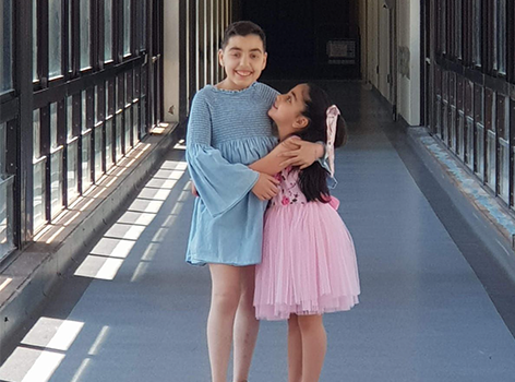 Alyssar and sister embracing