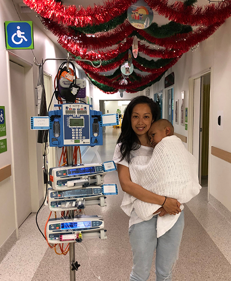 Mum holding Taiyo in hospital during Christmas